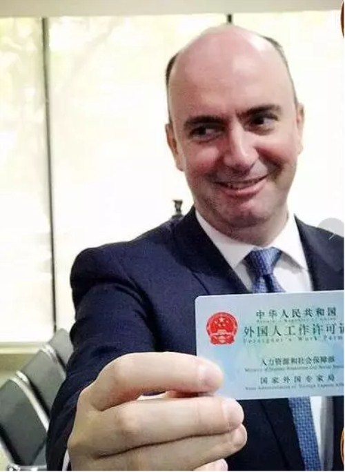 A foreigner displays his working permit card in Hangzhou, Zhejiang province.jpg