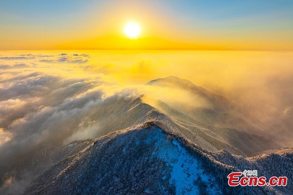 Sunrise scenery of clouds-shrouded snowy mountain in Hangzhou